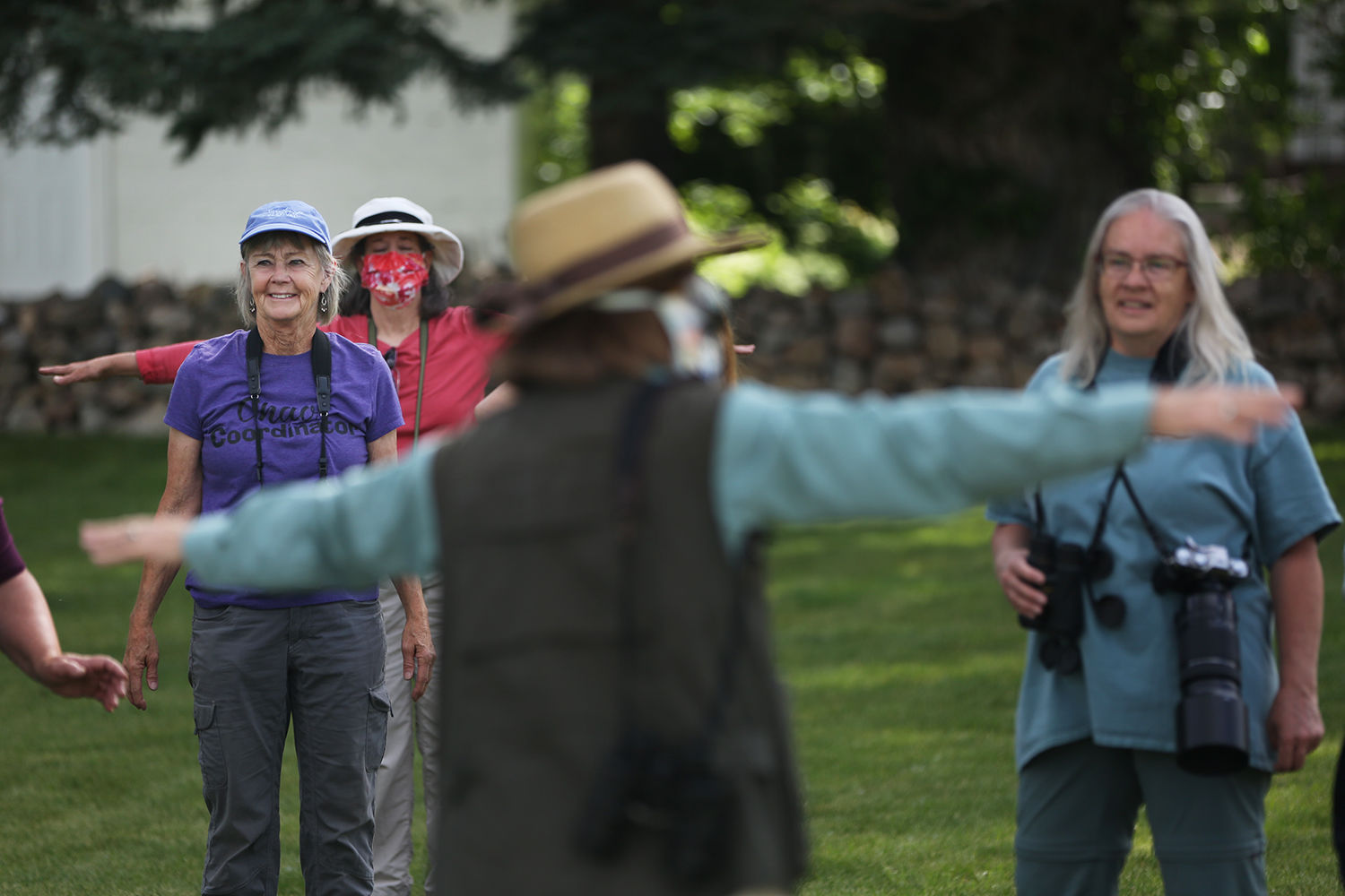 Gail Vanderpoel laughs as the group holds their wings up and flaps them to learn about the wings